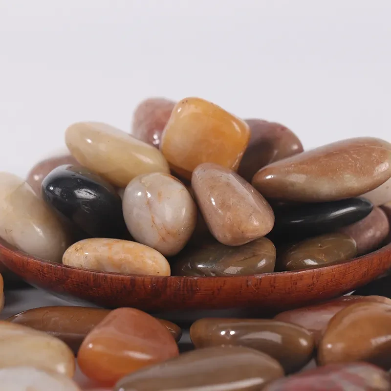 Smooth dark stones scattered across a tranquil surface in nature's serene landscape Smooth dark stones scattered across a tranquil surface in nature's serene landscape