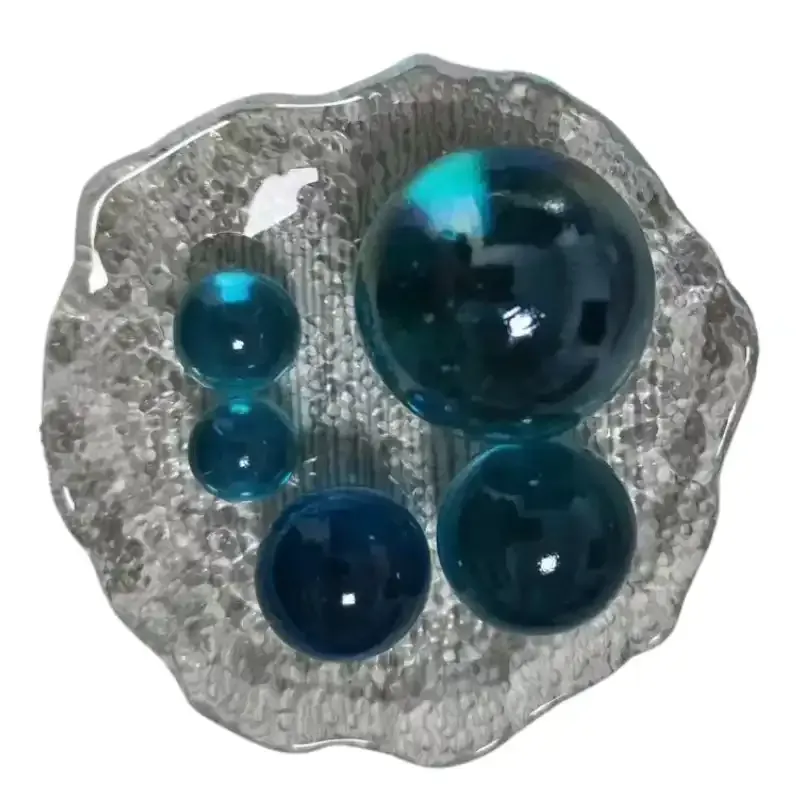 Round glass marbles are used to decorate toys