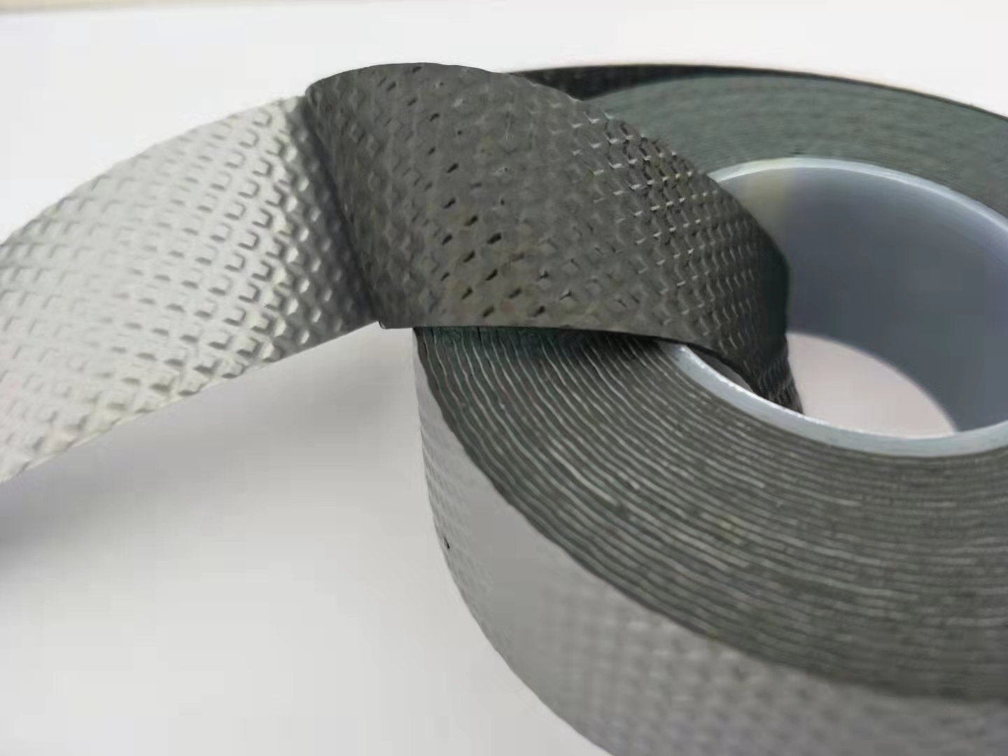 Black insulation tape made of fabric for electrical and automotive applications.
