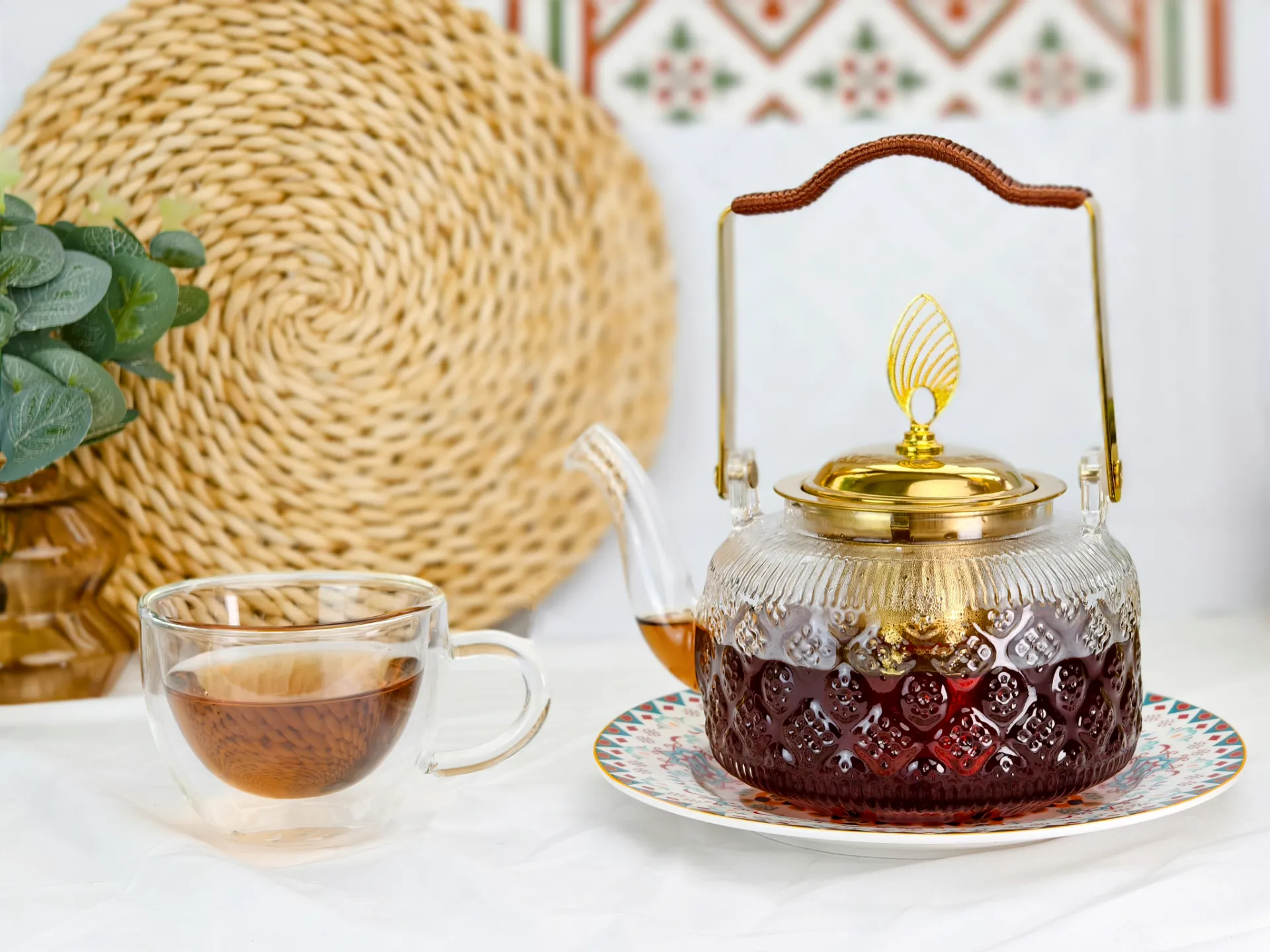 The 1L Floral-Embossed borosilicate Glass Teapot with golden infuser handle and lid