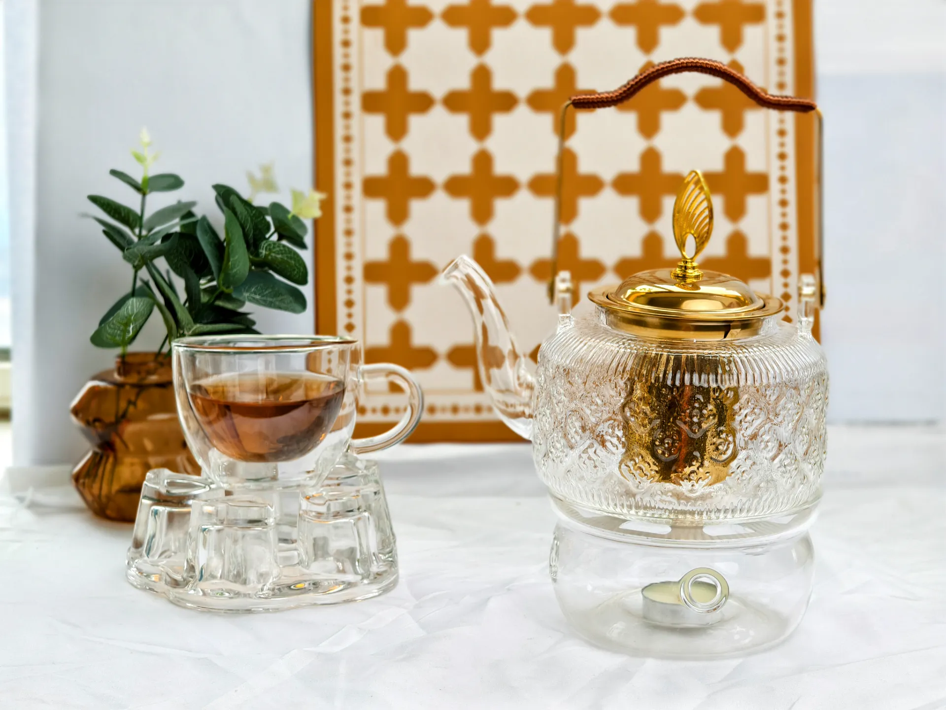 The 1L Floral-Embossed borosilicate Glass Teapot with golden infuser handle and lid