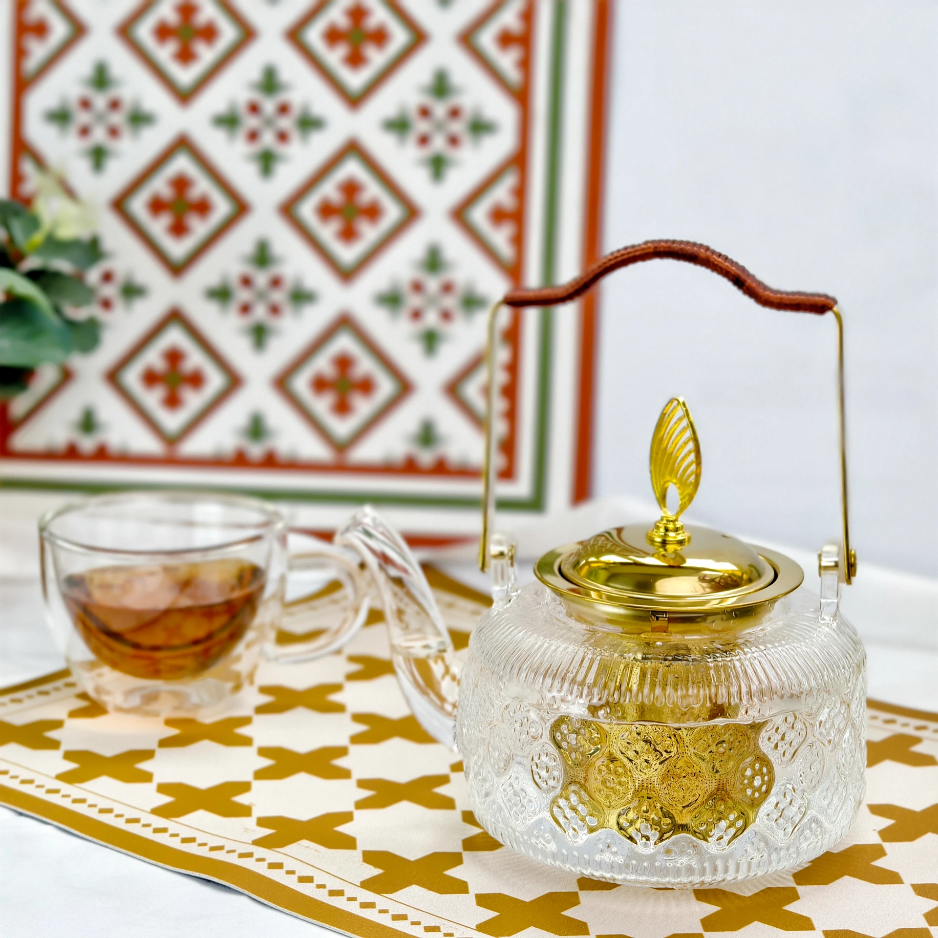 The 1L Floral-Embossed borosilicate Glass Teapot with golden infuser handle and lid